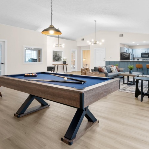 a clubroom with a pool table and chairs