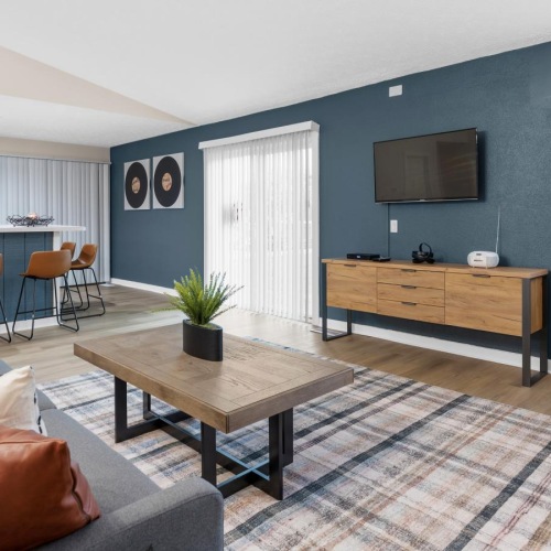 a clubroom with a tv, couch and a coffee table