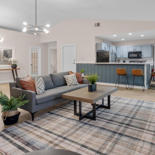 a clubroom with a chair, couch and coffee table